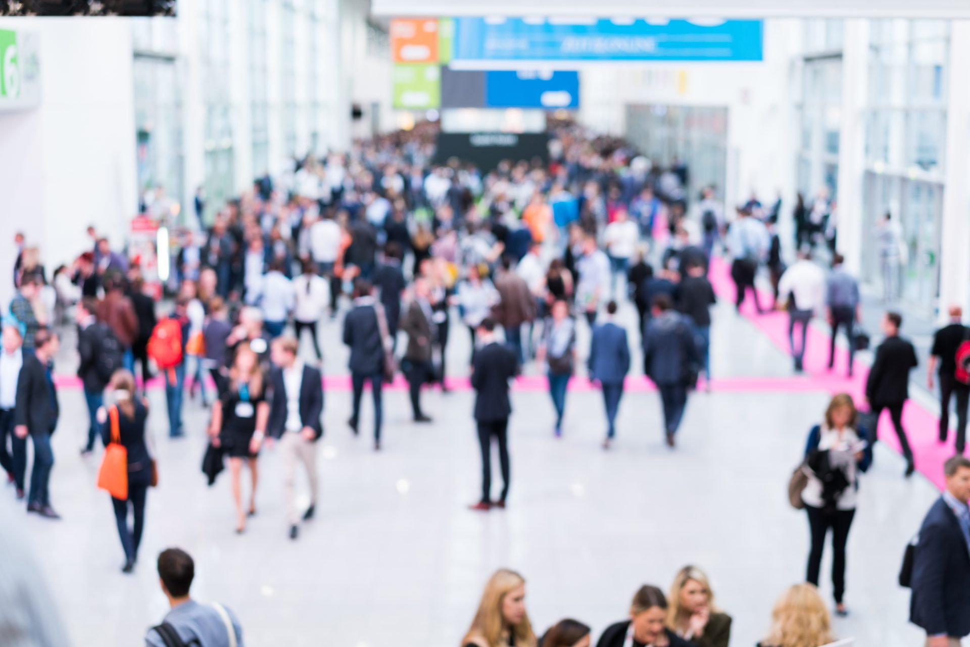 blurred people at a trade fair hall