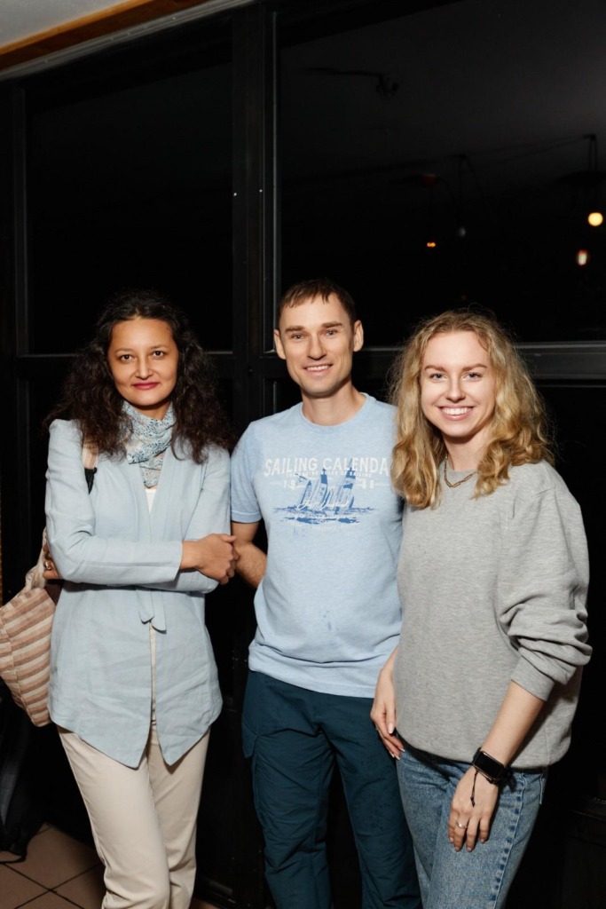 two girls and a man smiling