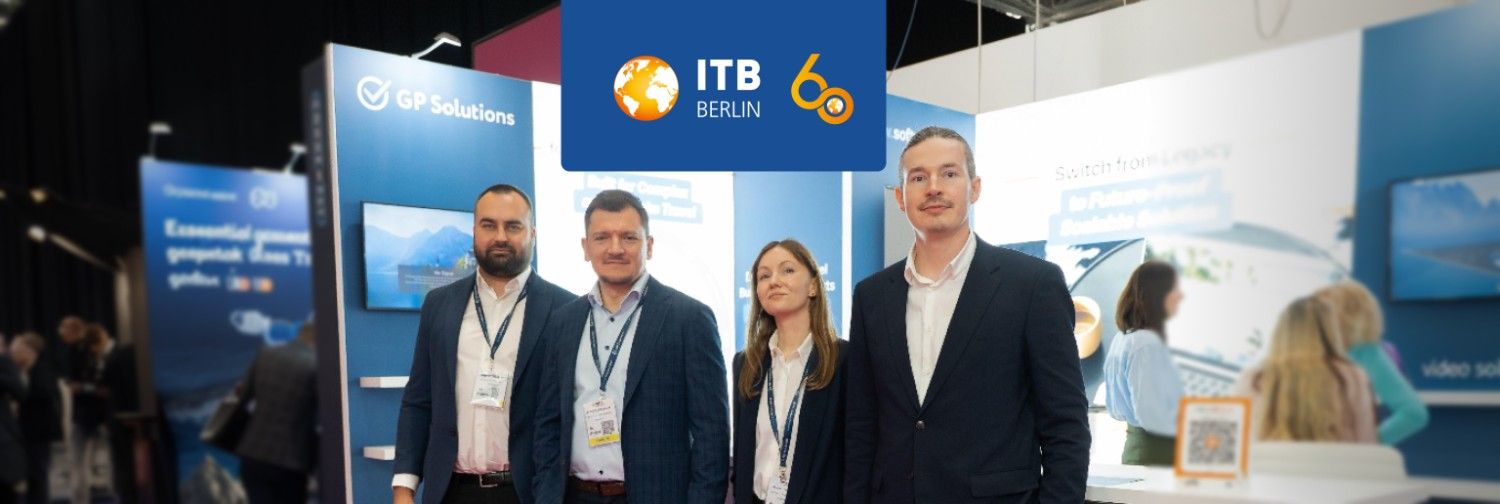 gp solutions employees in four standing in the front of an exhibition stand and welcomingly smiling