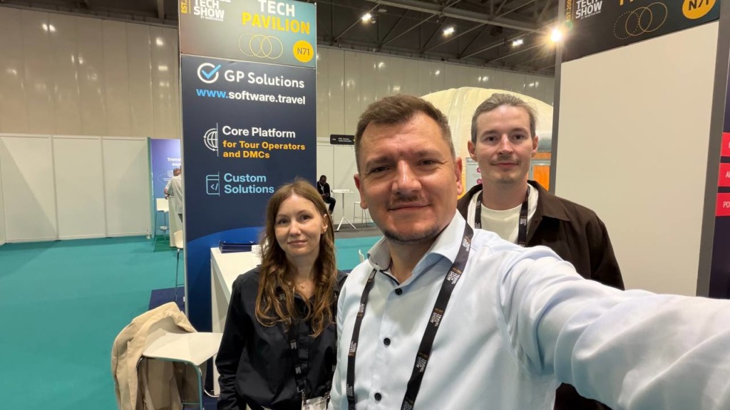 Selfie of GP SOlutions's team standing at the GP Solutions booth in the Travel Tech Show exhibition.